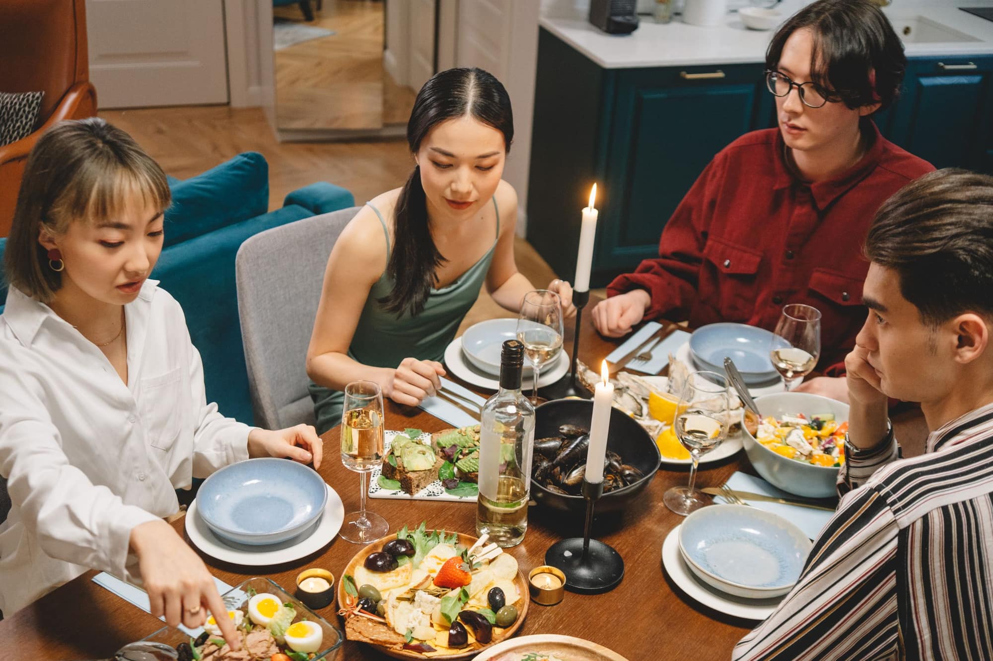 Friends sharing a candlelit dinner at night